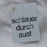 Postkarte "Schlauer durch aua" gestempelter Spruch